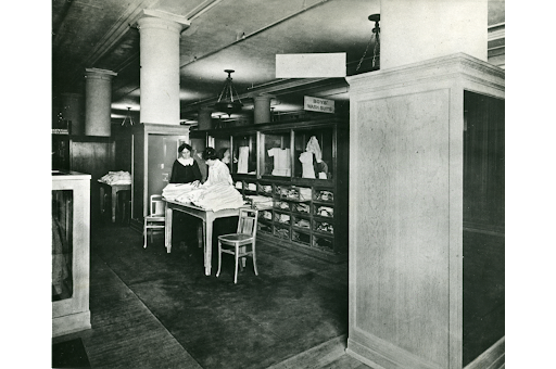Two unidentified students in the retailing class that developed into the Prince School of Retailing posed in the boy's clothing department at Filene & Sons Company in Boston, 1912, Courtesy of Simmons University Archives.