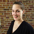Headshot of Laura Ballek Cole in front of a brick wall