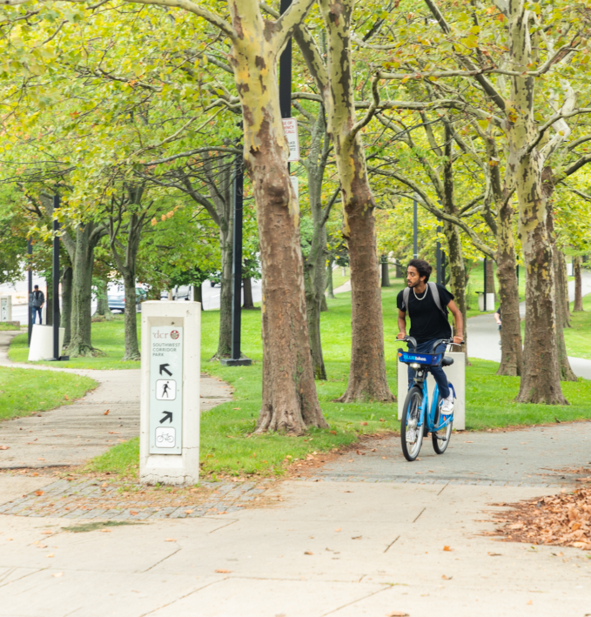 Man rides blue bike on the DCR Pathway trail